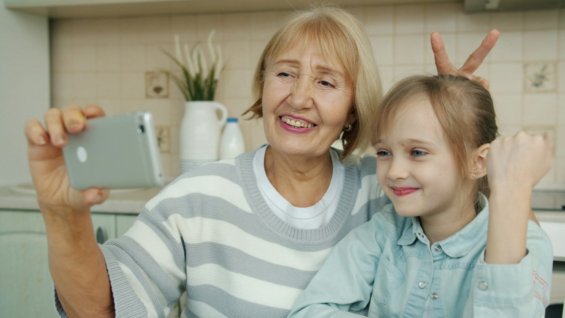 Grandmother and granddaughter smiling taking selfie