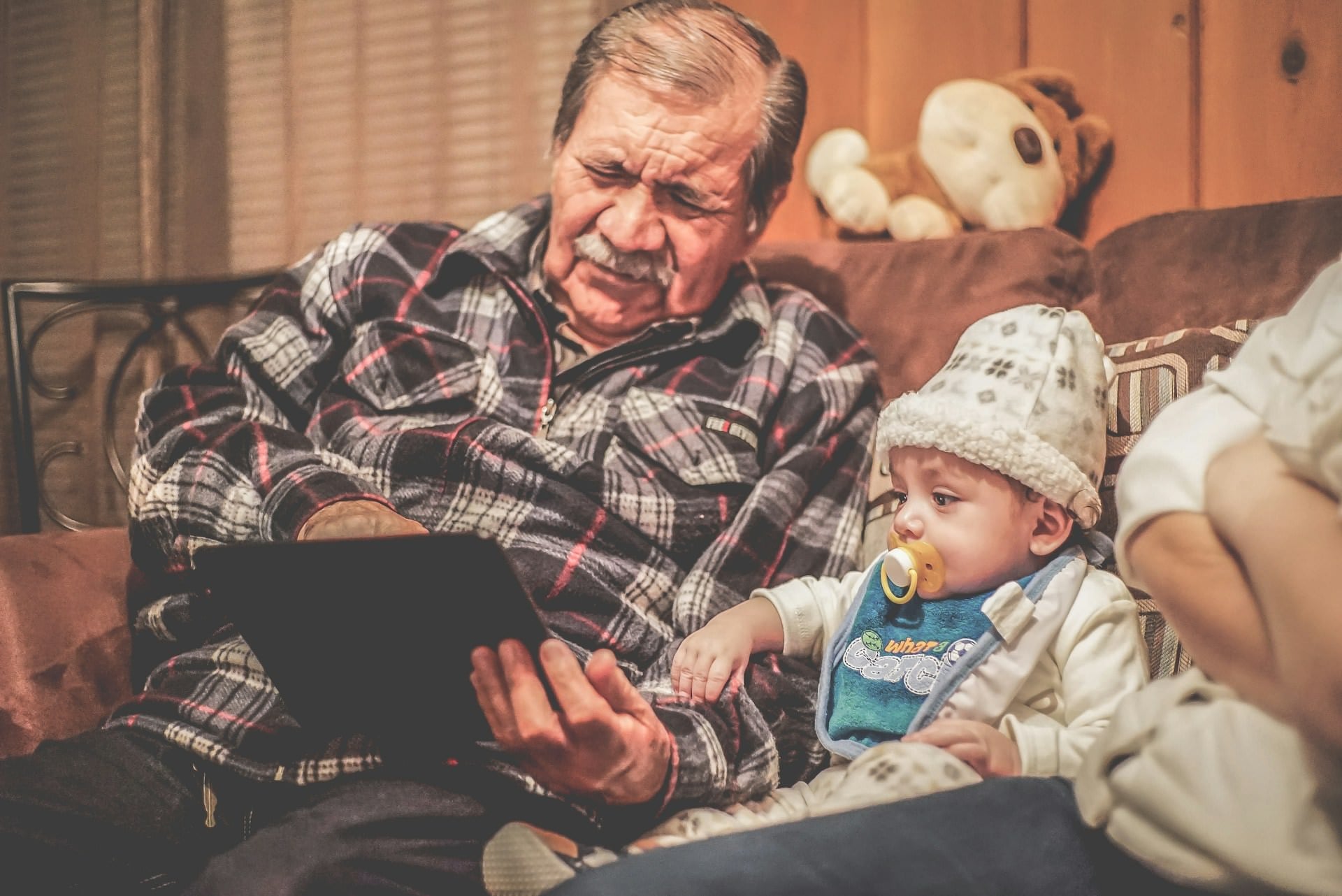 Grandfather and baby granddaughter reading